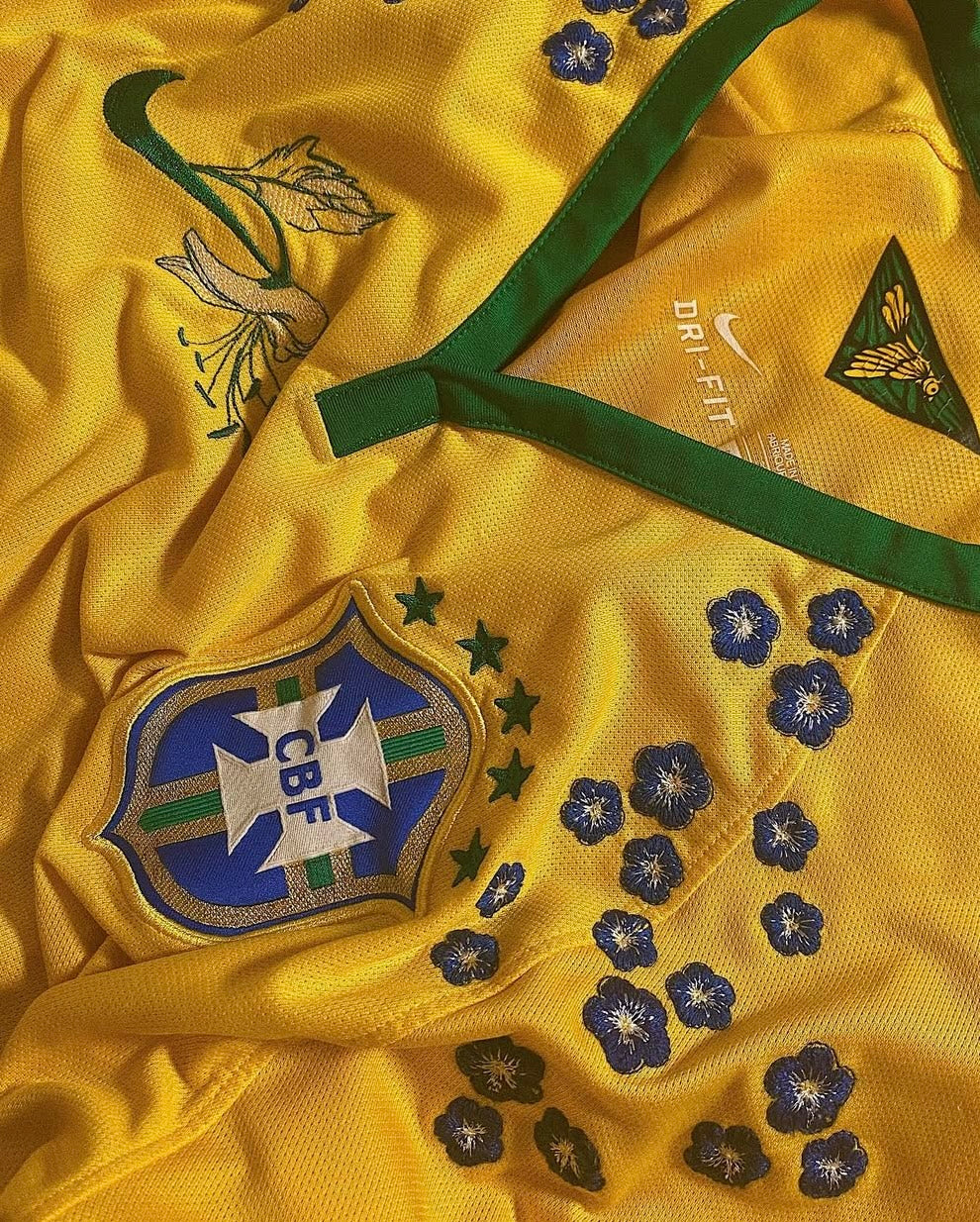 Close-up On The Brazil 'Samba' Edition 2014 Jersey Highlighting CBF Crest, and Extricate Blue Stitching Details