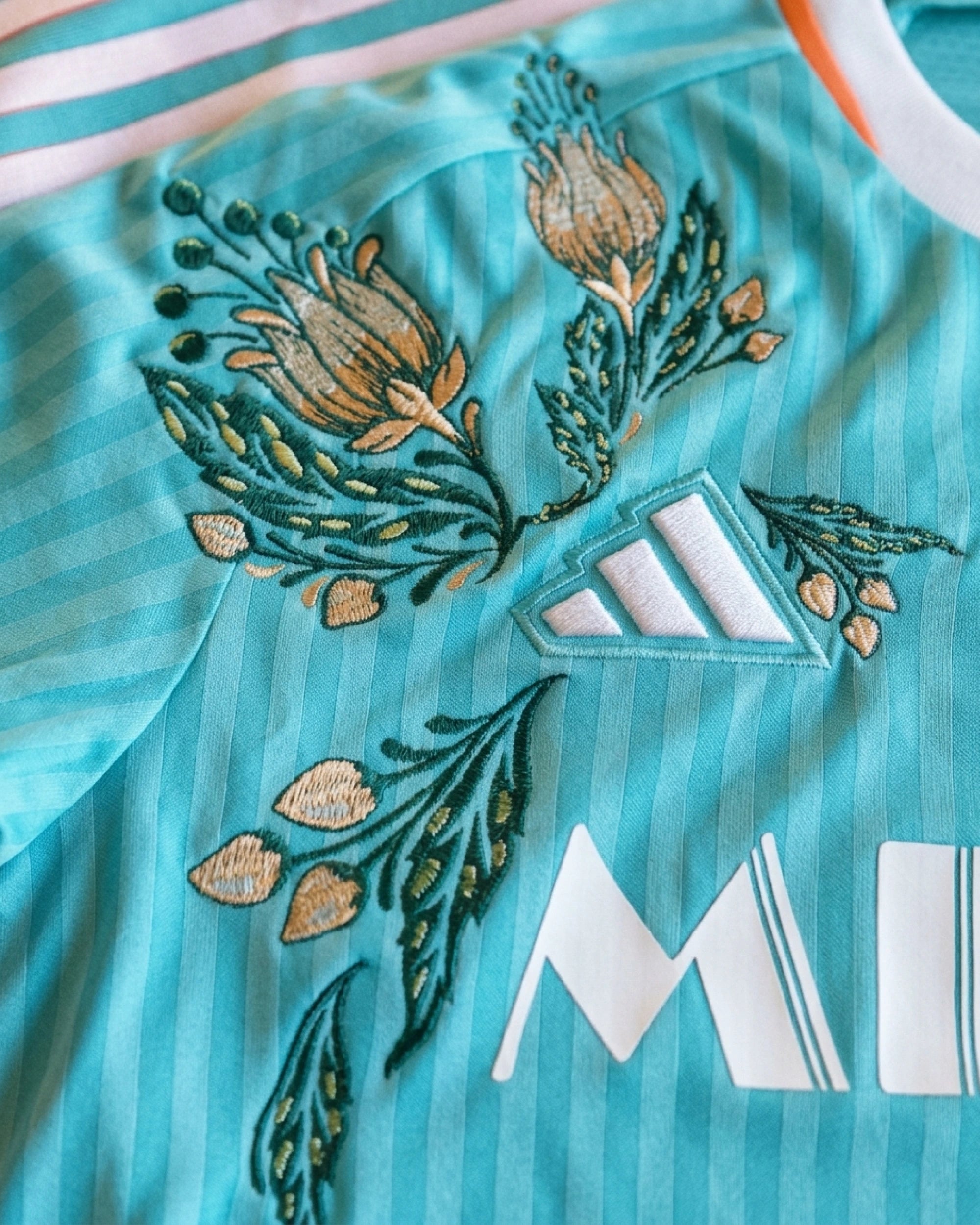 Detailed View Of The Sponsor Logo And Artisanal Hand-Guided Embroidery On The Sunrise Edition Concept Kit