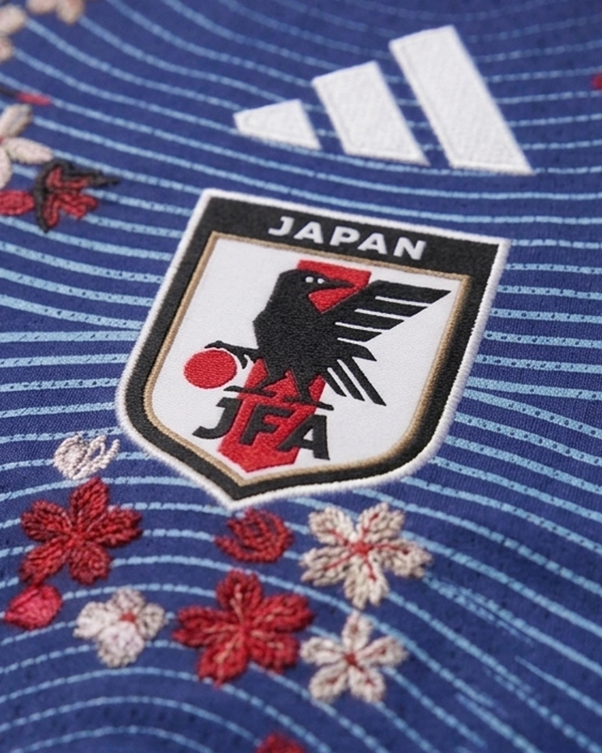 Macro Detail Of High-Density Floral Artisanal Embroidery Seamlessly Integrated On The Luxury Japan Concept Jersey.