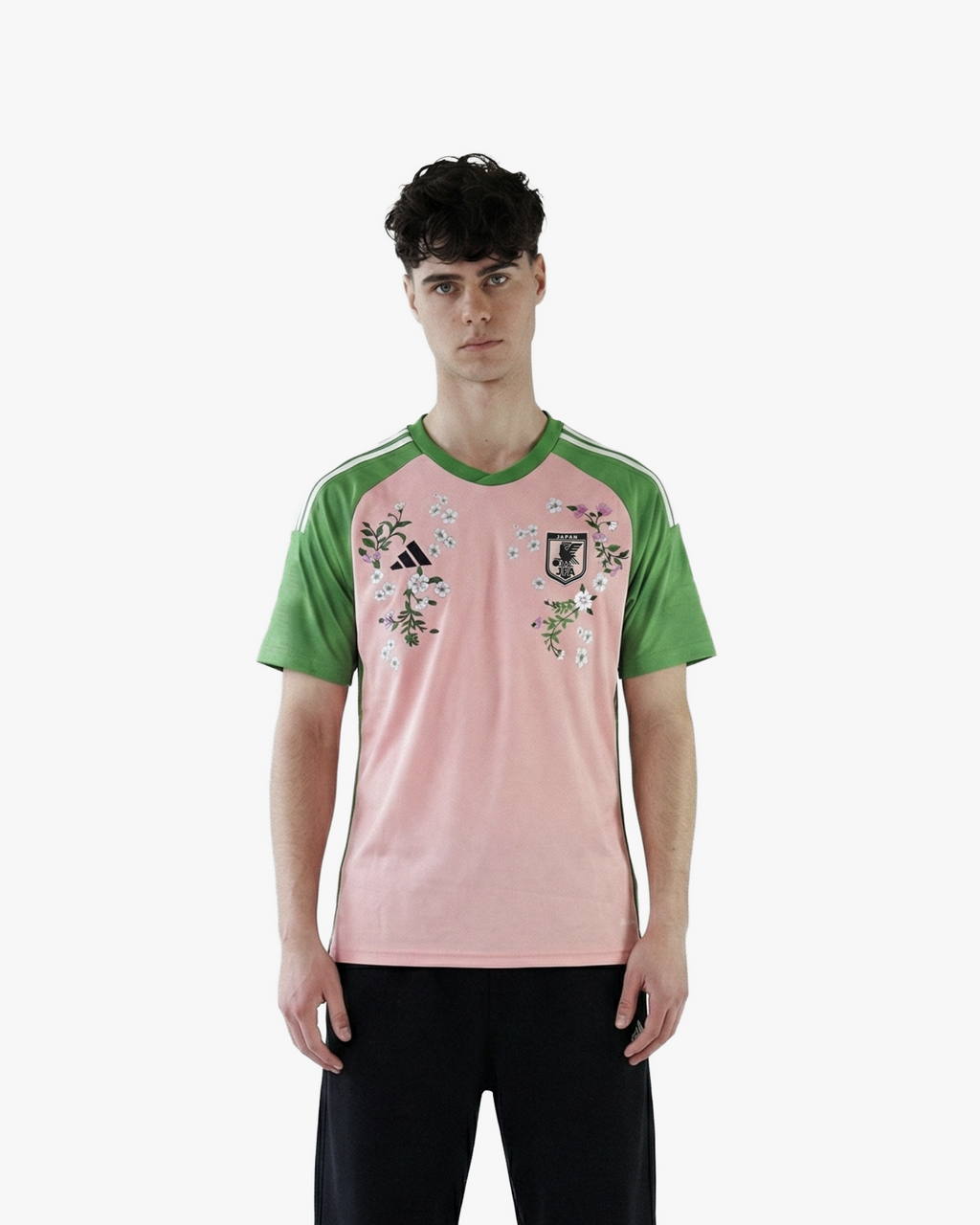 The Embroidered Japan Nigo 2022 jersey on model, highlighting its vibrant Sakura-inspired color palette and athletic fit.